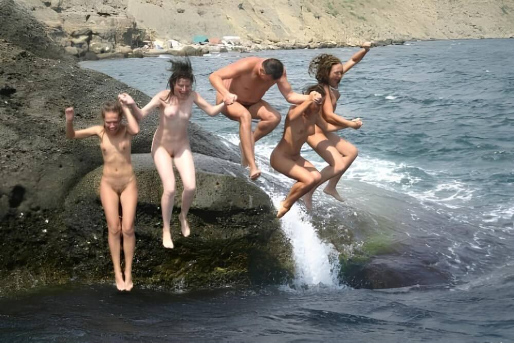 Mens and girls nudists on a beach - Health and well-being are enhanced through naturism and nudism